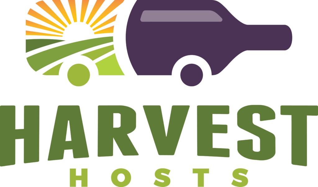 Logo for Harvest Hosts, featuring a stylized bottle-shaped RV with a sun rising over green fields. The word "HARVEST" is in large green letters, and "HOSTS" is in smaller green letters below.